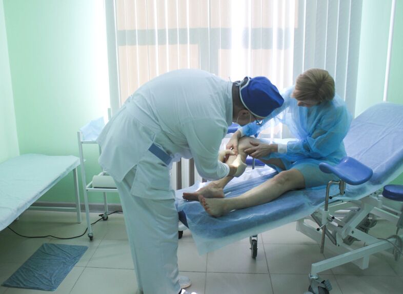 Un cirurxián examina as veas dun paciente antes de realizar unha operación.